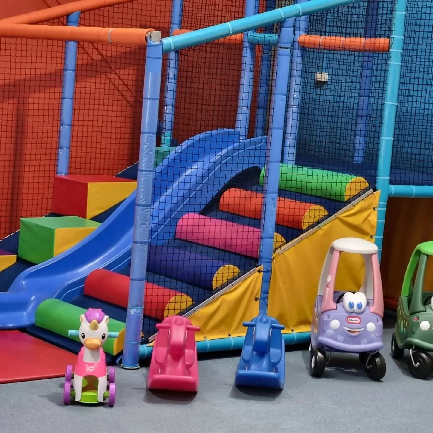 Soft play climbing frame with slide and ride-on toys at Meerkat Manner indoor play centre, Ocean Grove